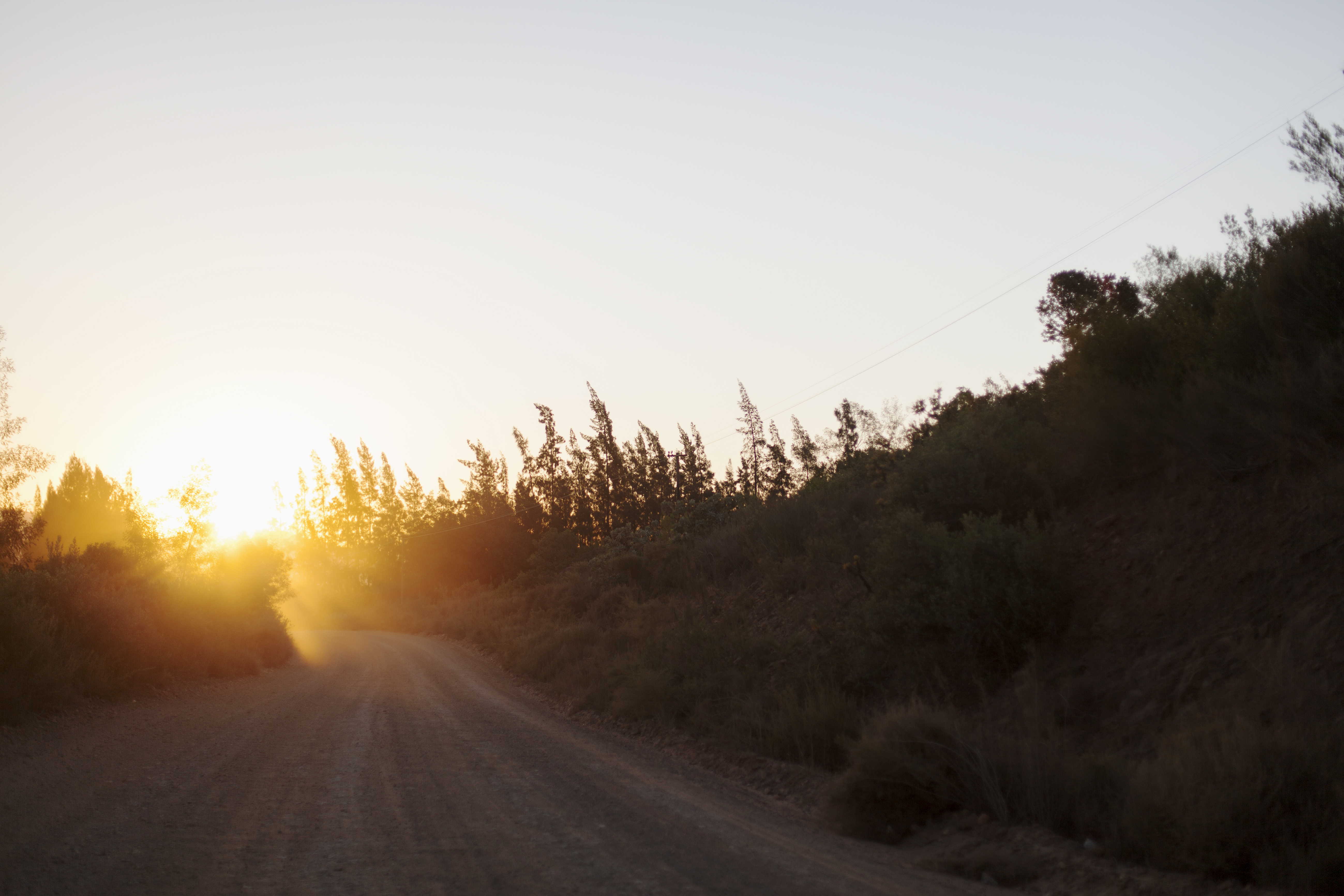 Gravel road in country with sunset